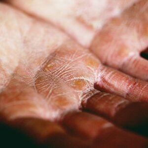 person holding brown and white textile