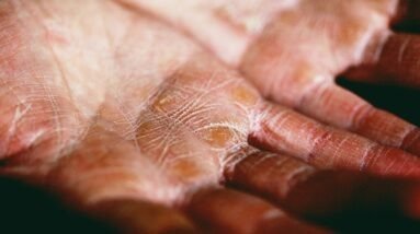 person holding brown and white textile