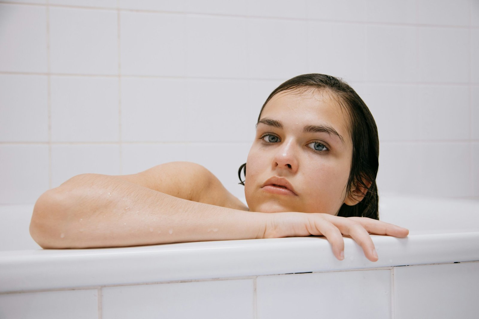 topless woman in white bathtub