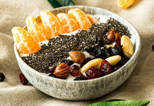 a bowl filled with fruit and nuts on top of a table